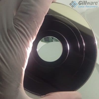 A hard drive platter with visible platter damage