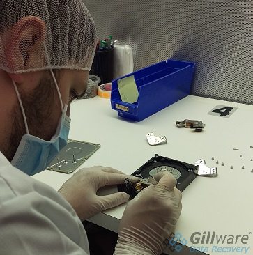 A cleanroom technician can recover hard drive data from a broken drive.