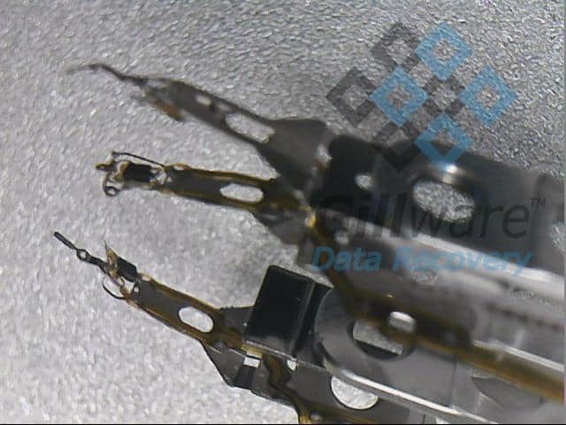 Mangled read/write heads as seen under magnification. Read/write heads are a common point of physical hard drive failure.
