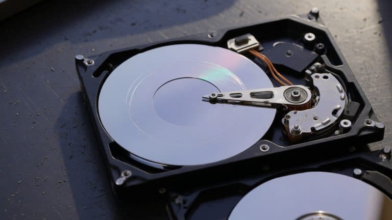 Opened hard disk drive showing platters and read/write head arm