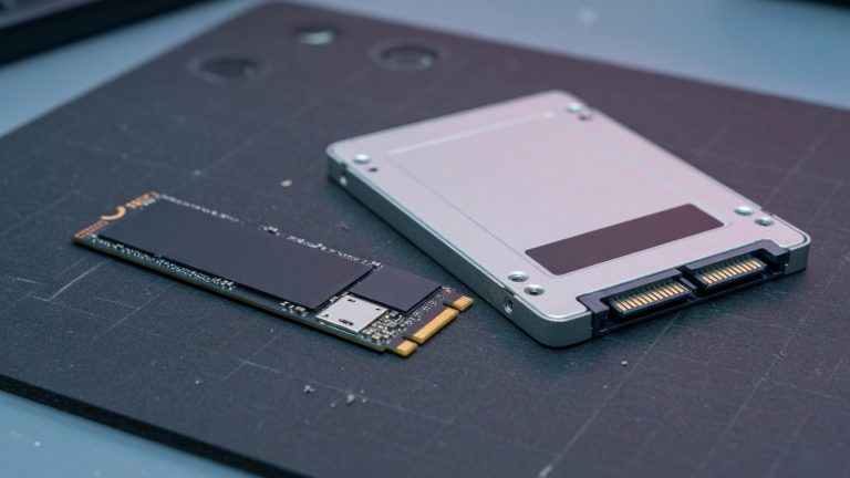 An M.2 NVMe SSD and a 2.5-inch SATA SSD on a lab workbench
